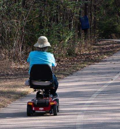 A person riding a scooter on a road